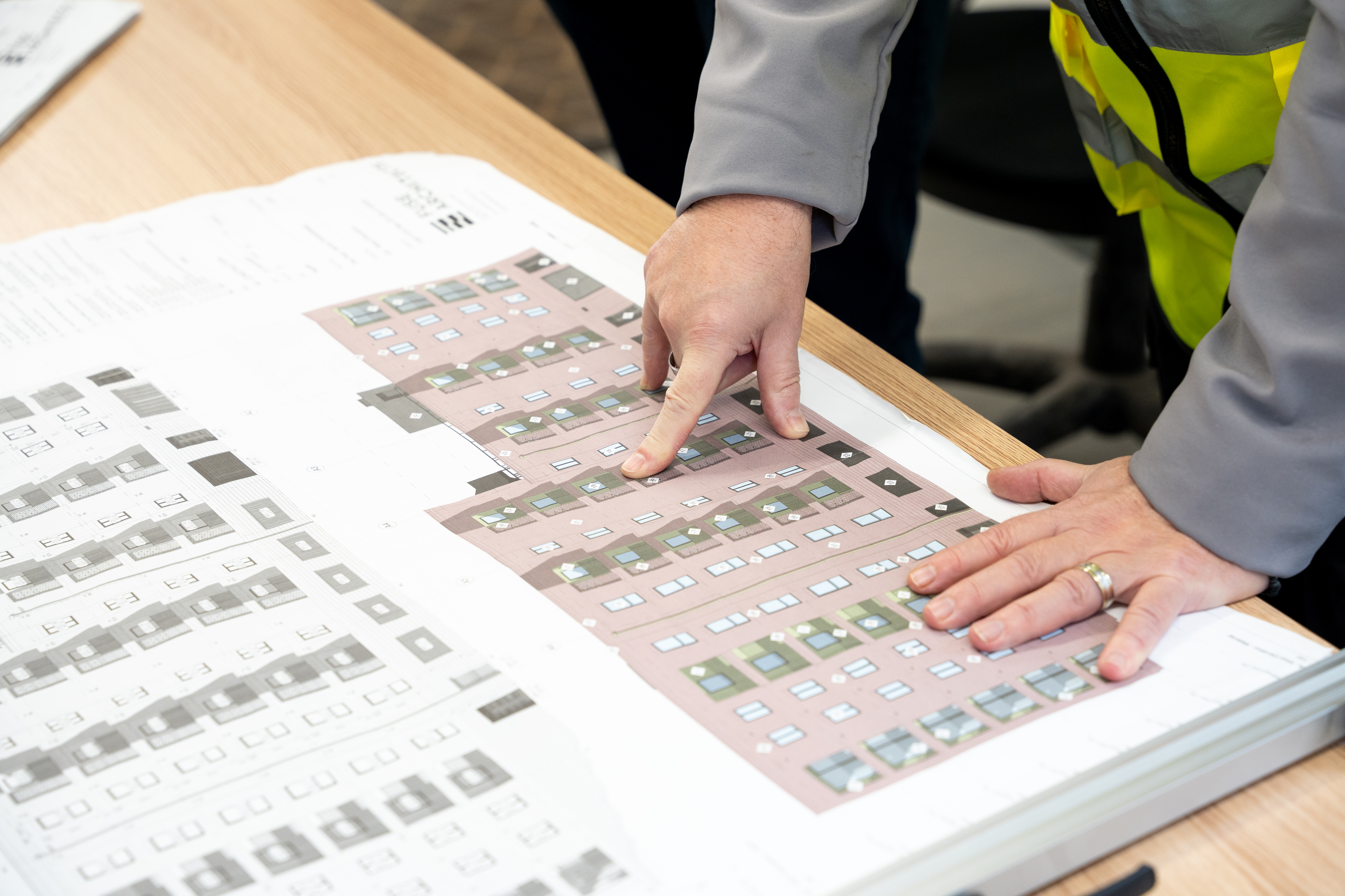 Principal Designer reviewing architectural drawings on a project site